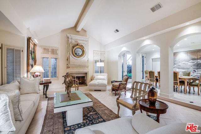 living room with beam ceiling and high vaulted ceiling