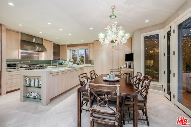 dining space with light parquet flooring and a chandelier