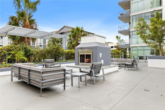 view of patio / terrace featuring a balcony and an outdoor living space with a fireplace