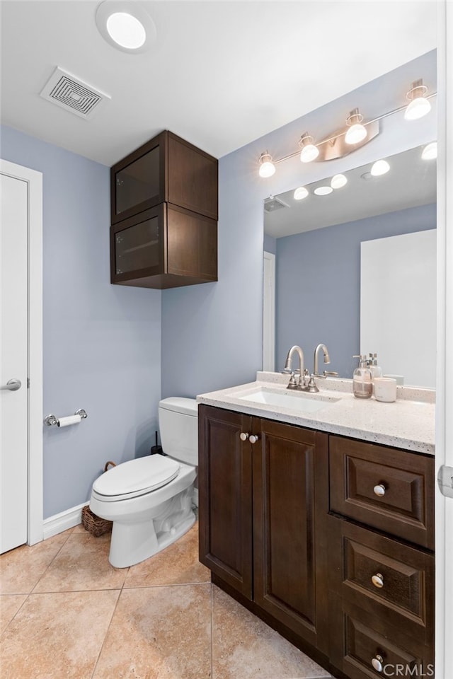 bathroom with vanity, toilet, and tile patterned flooring