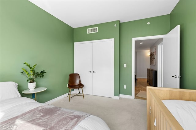 bedroom featuring a closet and light colored carpet