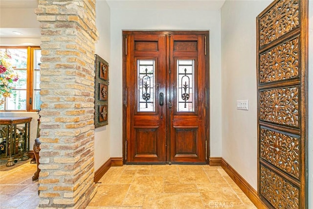 entrance foyer with ornate columns and a wealth of natural light