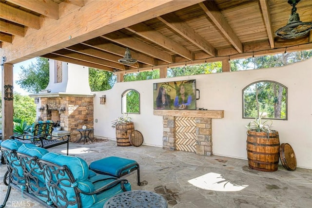 view of patio with an outdoor living space with a fireplace