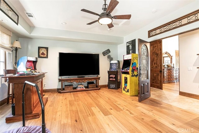 living room with ceiling fan and wood-type flooring