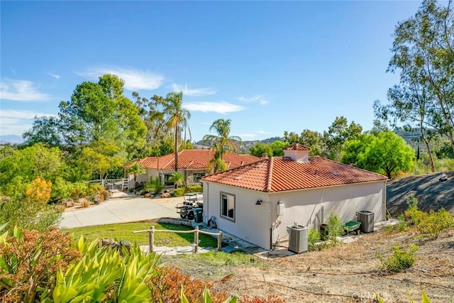 view of property exterior featuring central AC and a patio