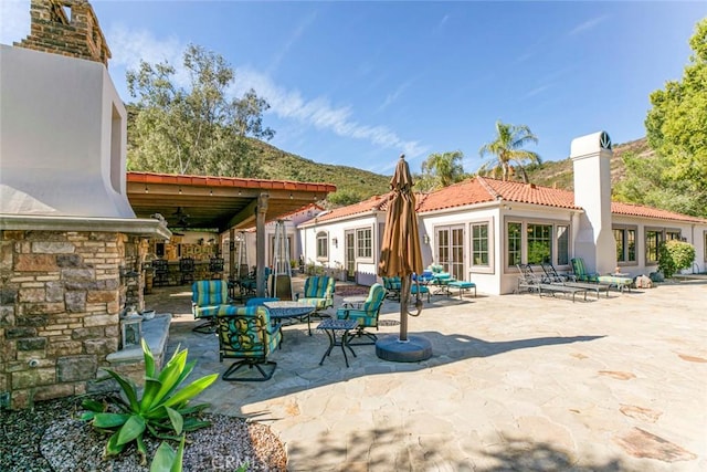 rear view of house featuring a patio area and ceiling fan