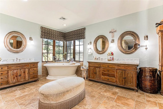 bathroom with a washtub and vanity