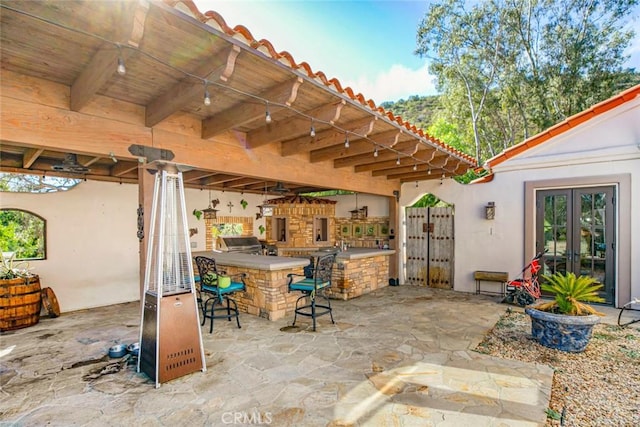 view of patio with exterior bar and an outdoor kitchen