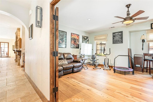 living room with ceiling fan and light hardwood / wood-style floors