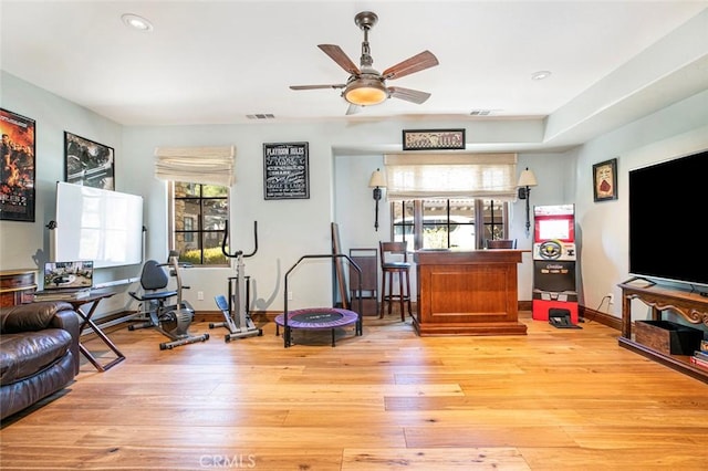 living room featuring light hardwood / wood-style flooring, plenty of natural light, and ceiling fan