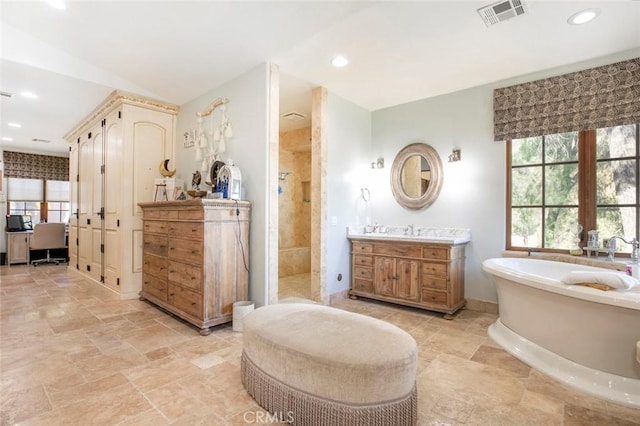 bathroom featuring shower with separate bathtub and vanity