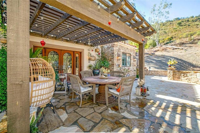 view of patio / terrace with french doors and a pergola