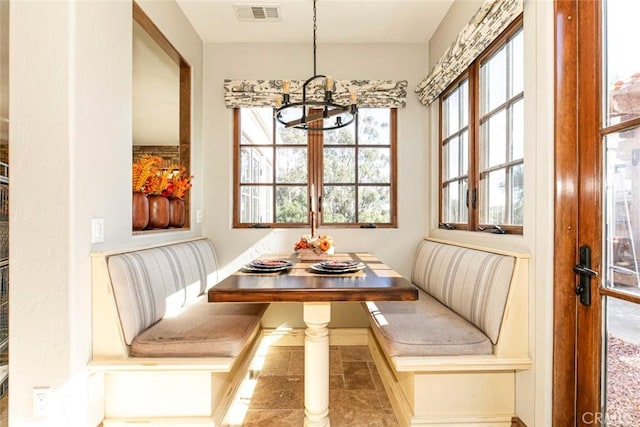 dining space with breakfast area and a notable chandelier