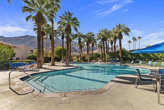 view of swimming pool featuring a mountain view and a patio area