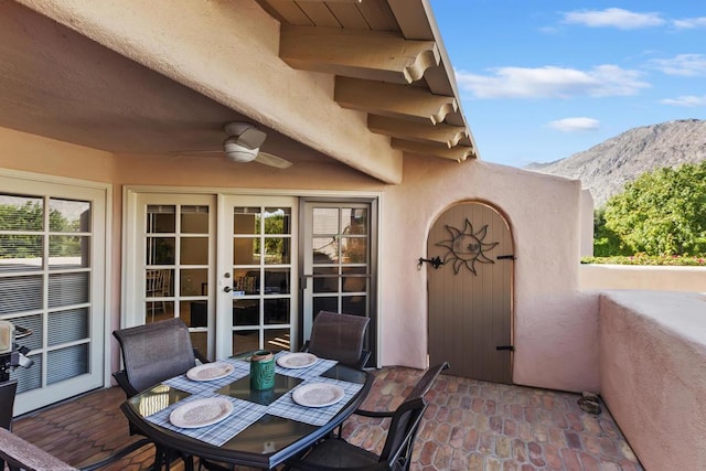 view of patio / terrace with ceiling fan and a mountain view