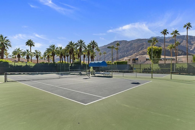 view of tennis court featuring a mountain view