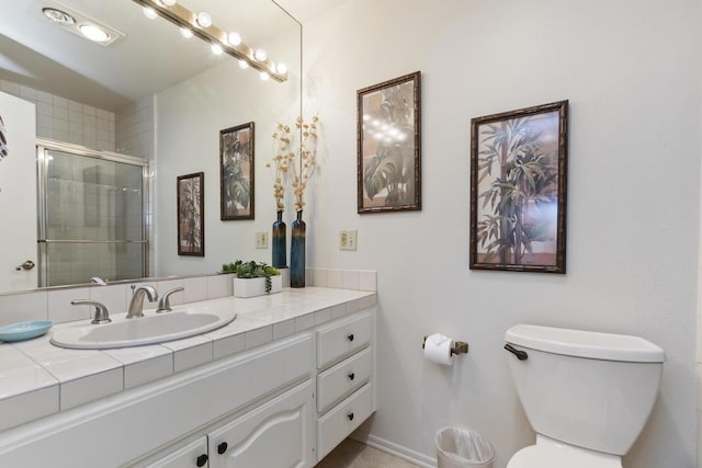 bathroom with vanity, an enclosed shower, and toilet