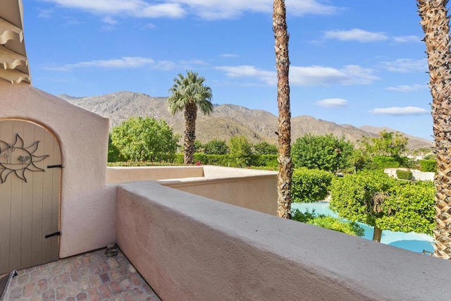 view of patio / terrace with a balcony and a mountain view