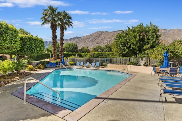 view of pool featuring a mountain view and a patio area