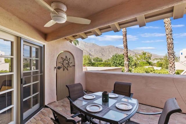 view of patio / terrace with ceiling fan, a balcony, and a mountain view