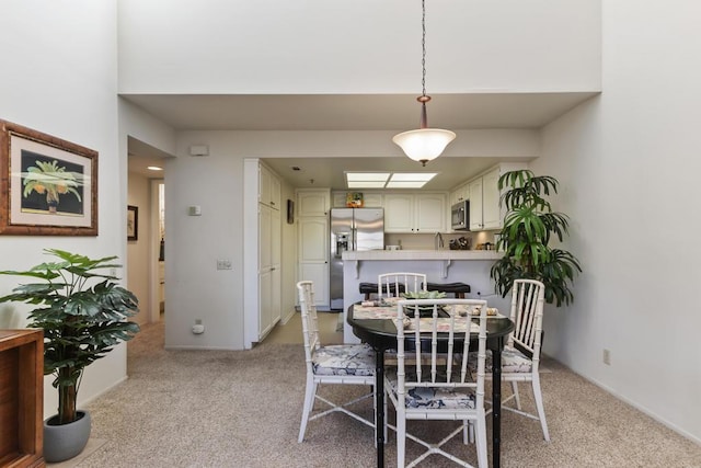 dining area with light colored carpet