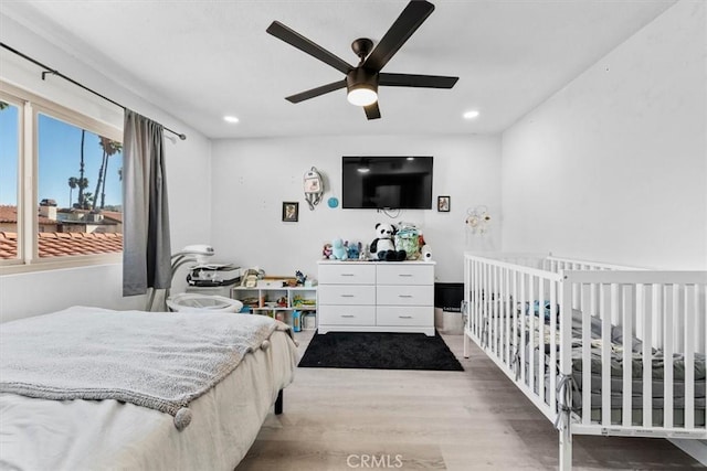 bedroom with ceiling fan, wood finished floors, and recessed lighting