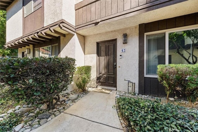 entrance to property featuring stucco siding