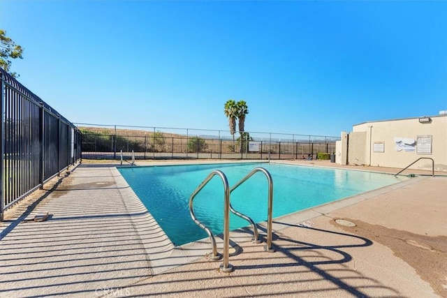 community pool featuring a patio area and fence