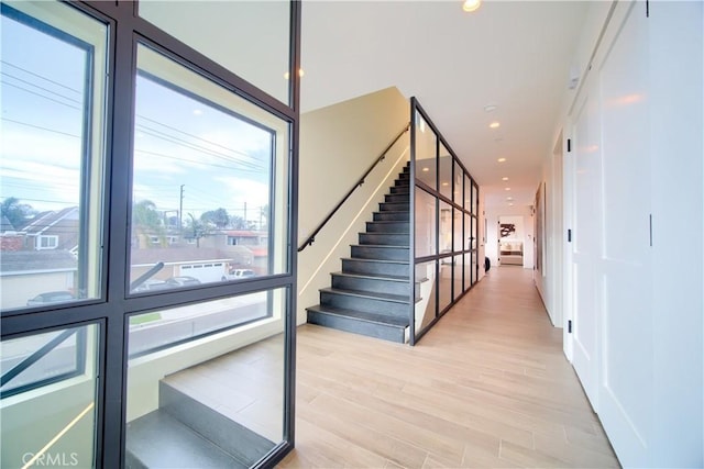 stairs with hardwood / wood-style flooring