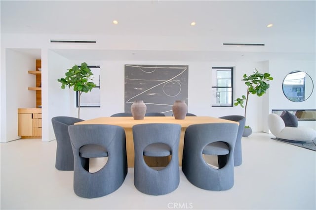 dining space with recessed lighting and finished concrete flooring