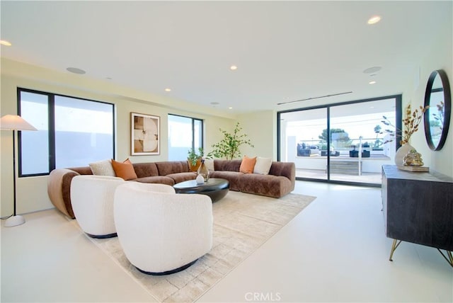 living room featuring finished concrete floors, plenty of natural light, and recessed lighting