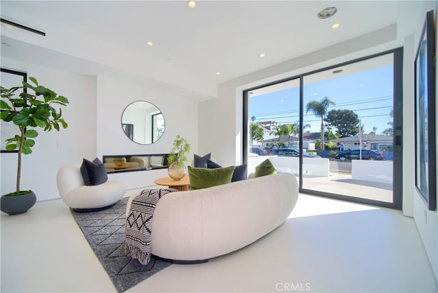 living area featuring recessed lighting and concrete flooring