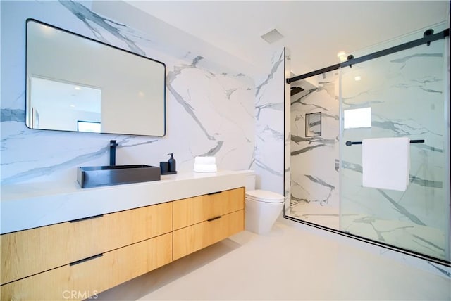 bathroom featuring vanity, toilet, and walk in shower