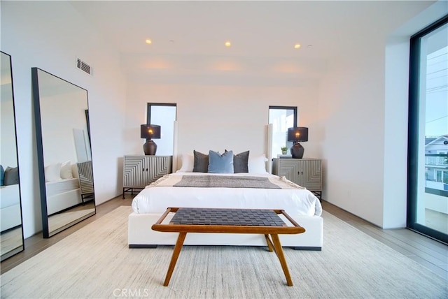 bedroom featuring visible vents, light wood-type flooring, and recessed lighting