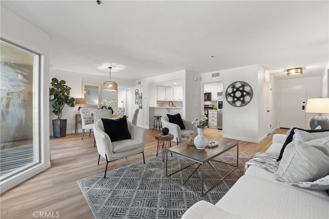 living room with light hardwood / wood-style floors