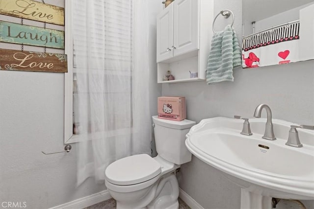 bathroom featuring sink and toilet