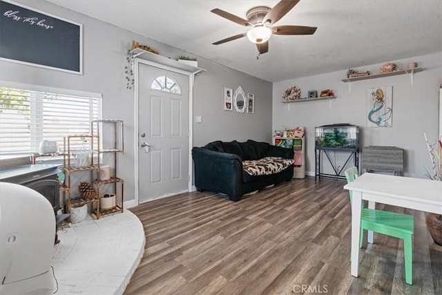 living room featuring wood-type flooring and ceiling fan