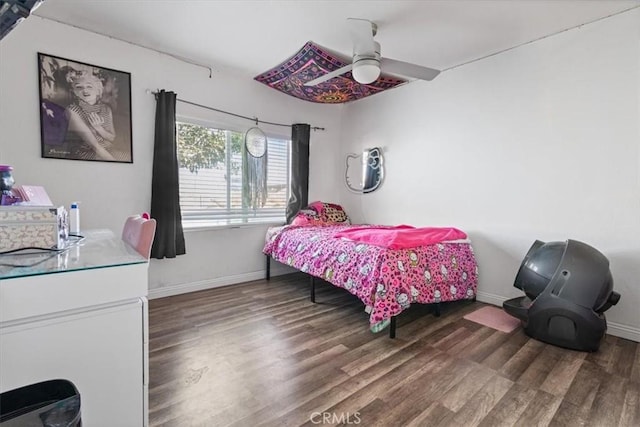 bedroom with ceiling fan and dark wood-type flooring