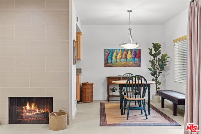 tiled dining area with a fireplace