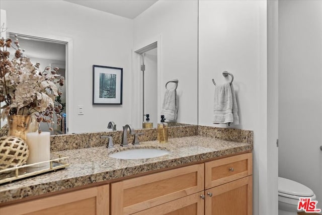 bathroom with vanity and toilet