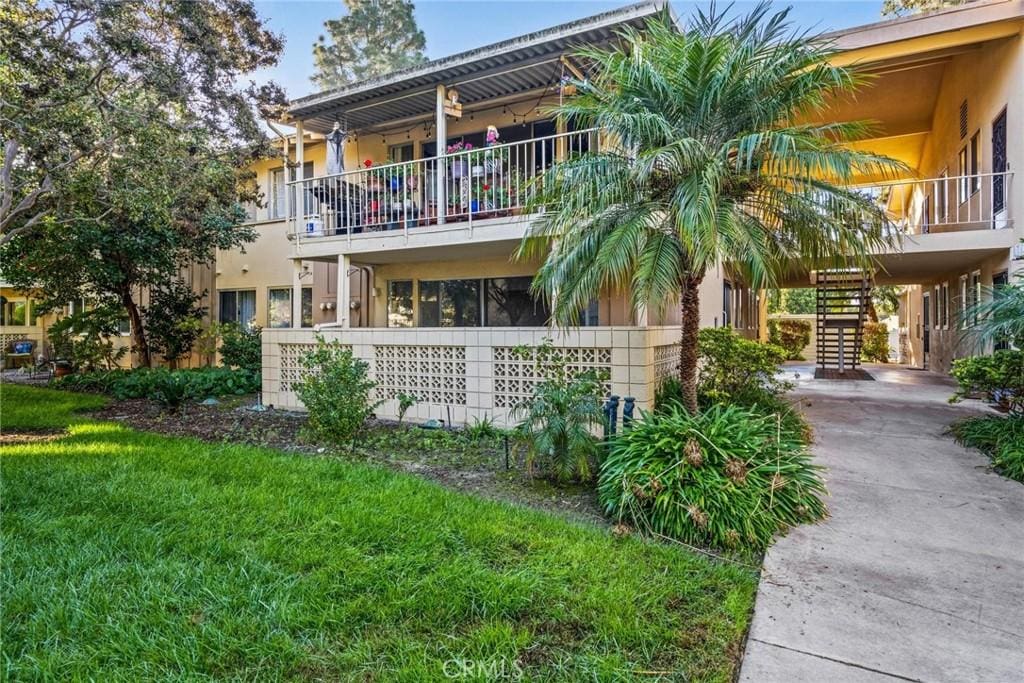 view of front of property with a front lawn and a carport