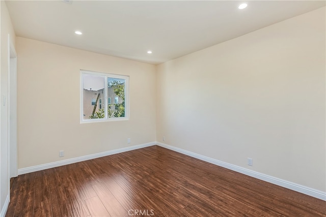 unfurnished room with dark hardwood / wood-style floors