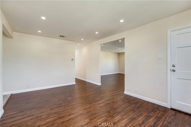 spare room with dark wood-type flooring