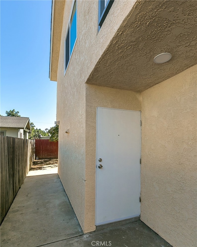 view of exterior entry featuring a patio