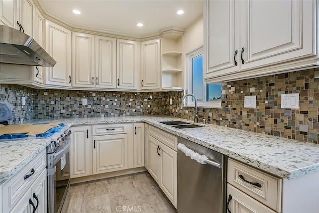 kitchen with decorative backsplash, light hardwood / wood-style flooring, sink, appliances with stainless steel finishes, and light stone counters