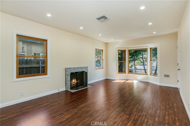 unfurnished living room featuring dark hardwood / wood-style floors