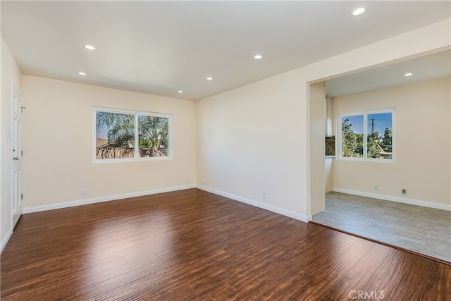 empty room featuring dark hardwood / wood-style flooring