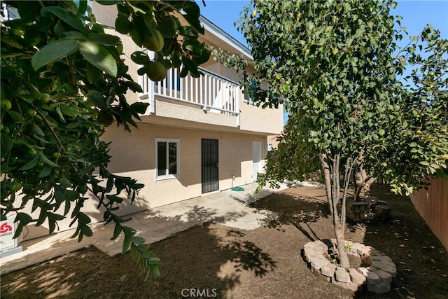 back of house with a patio and a balcony