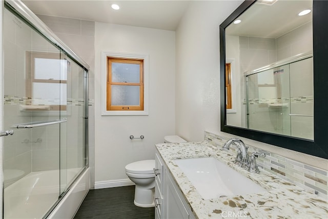 full bathroom featuring vanity, toilet, enclosed tub / shower combo, and backsplash