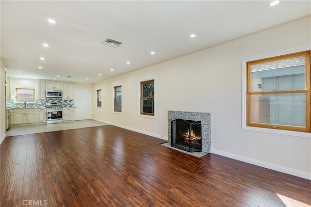 unfurnished living room with wood-type flooring